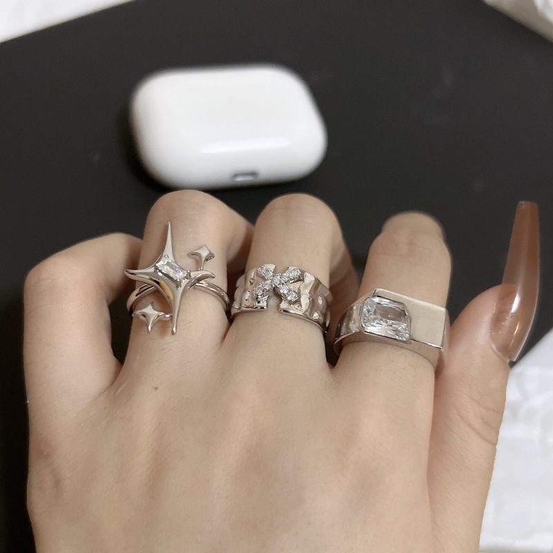 A niche starlight couple ring with a Korean Instagram trendy design sense, featuring letters X and zircon texture. It's fashionable and individualistic for women full figure