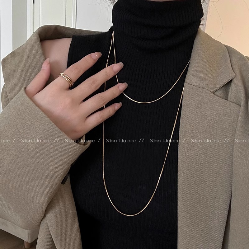 A long, layered golden snake bone chain and plain chain necklace with a simple and elegant style. It's a trendy and versatile sweater chain for women details Picture