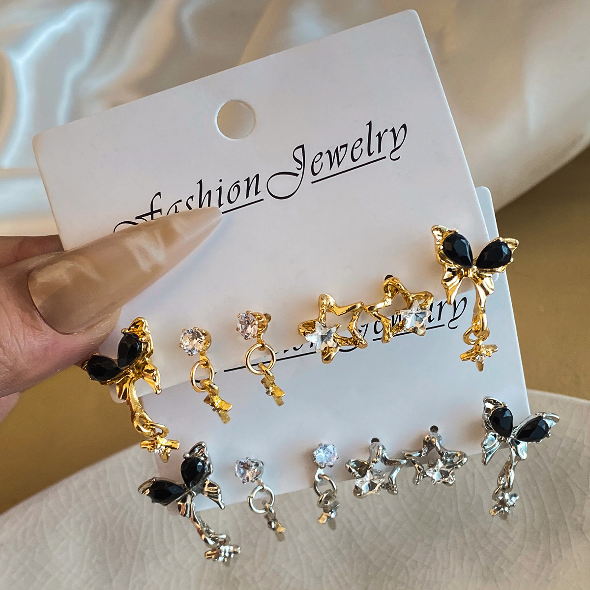 High-end black butterfly water diamond star earrings, retro tassel cross stud earrings for girls, fashionable three pieces of earrings for women full figure