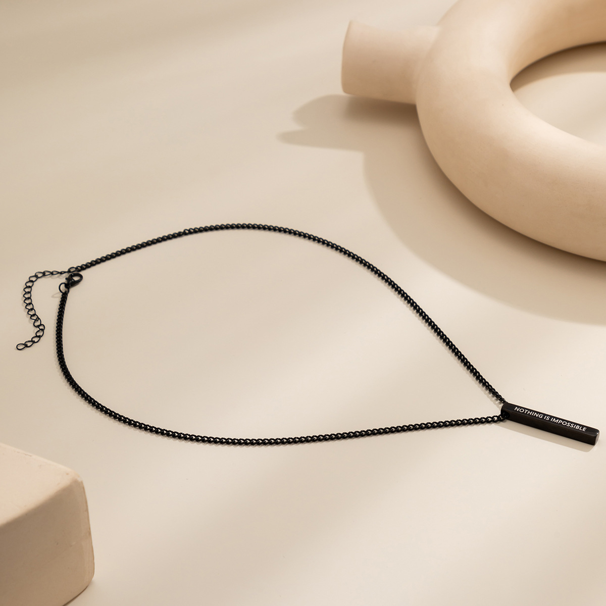 A sweet and cool black spray-painted long pendant necklace from Europe and America, a simple and elegant letter-shaped titanium steel necklace for women details Picture