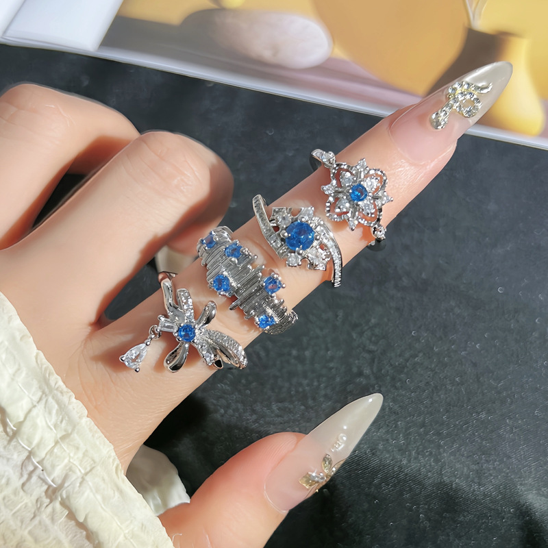 A mid-style sea blue zircon irregular pleated ring with a touch of luxury and sophistication for women, featuring a starry sky bow tassel ring full figure