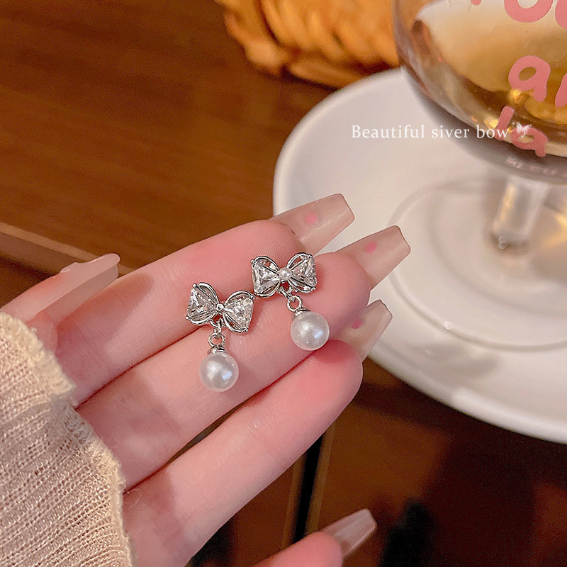 S925 Silver Needle Bow Pearl Earrings, a versatile and high-end summer trendy and popular ear accessory wholesale full figure
