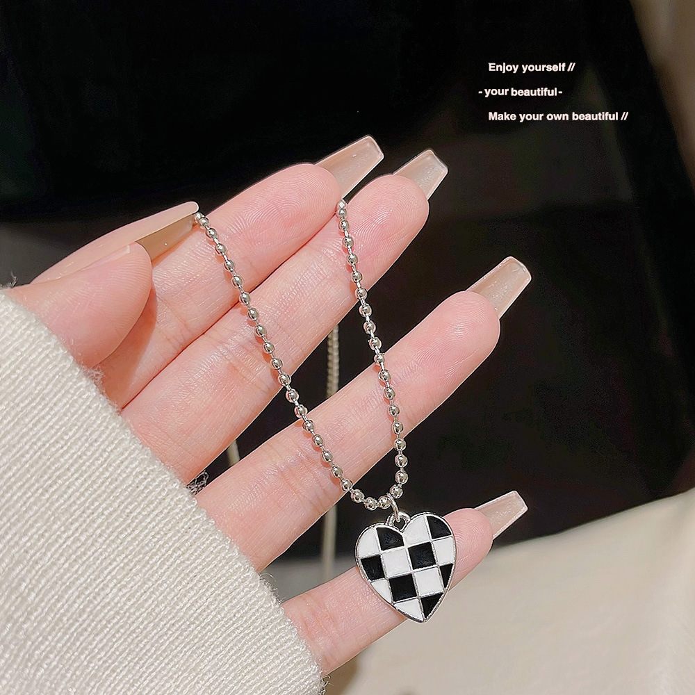 Stainless steel necklace with a high-end female feel, black and white heart-shaped chessboard pendant, light luxury, ins style collarbone chain, popular sweater chain Application Scenario