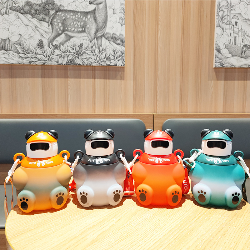 E-commerce wholesale new children's cute water cups with high appearance level, featuring straws, carrying straps, water bottles, portable and direct drinking bear water cups full figure