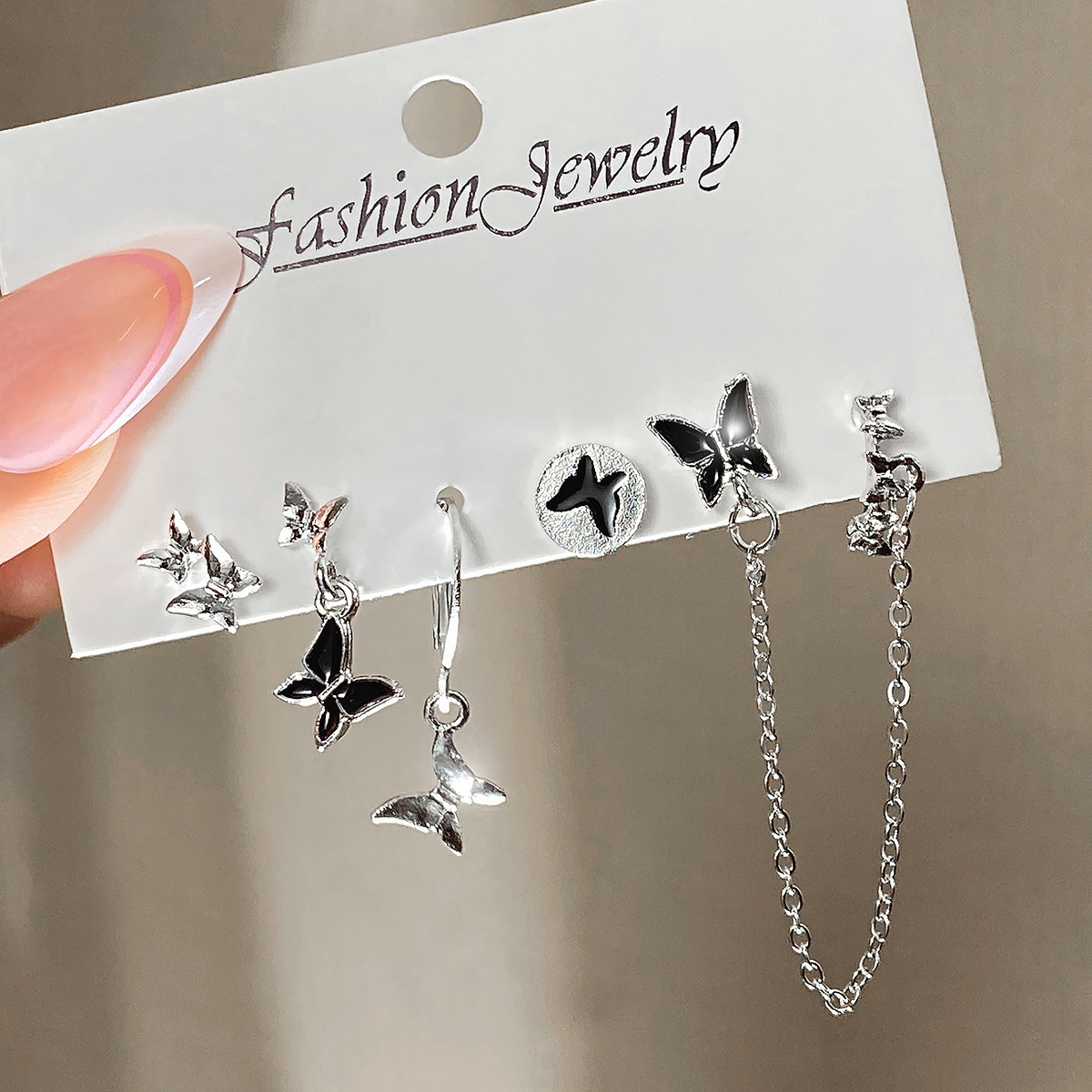 A new cross-border best-selling oil-dripping butterfly earring set of five pieces for women, featuring black metal and elegant earrings full figure