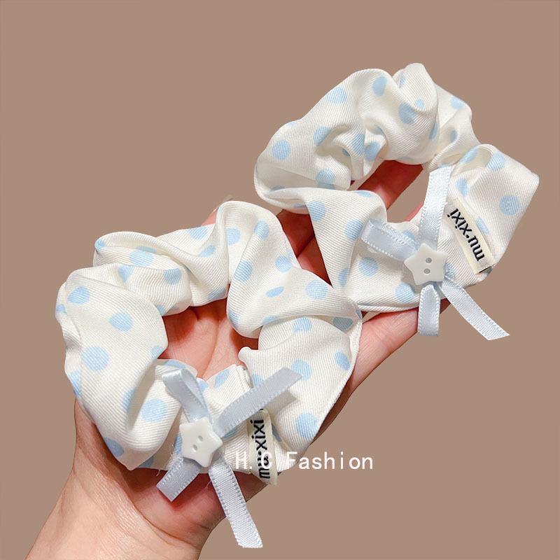 The Korean-style blue polka dot large intestine hair band exudes a high-end and laid-back vibe for women. It features a low ponytail hair accessory and a simple hair tie details Picture