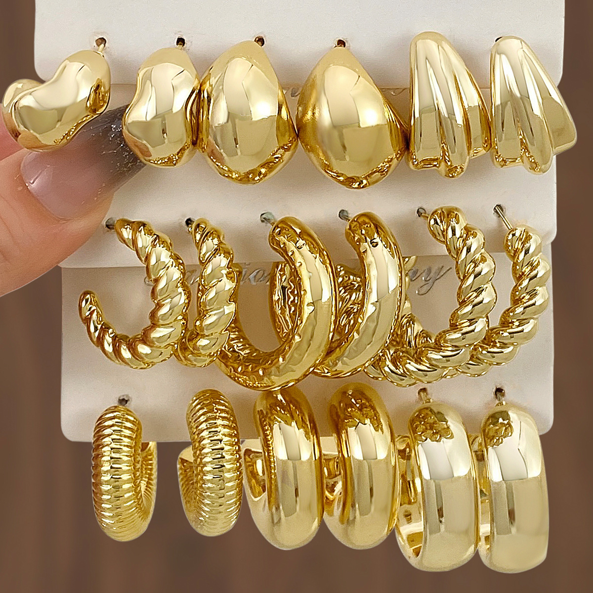 A new set of 3 pairs of high-end gold and exaggerated ccb earrings with a unique twist pattern from Europe and America full figure