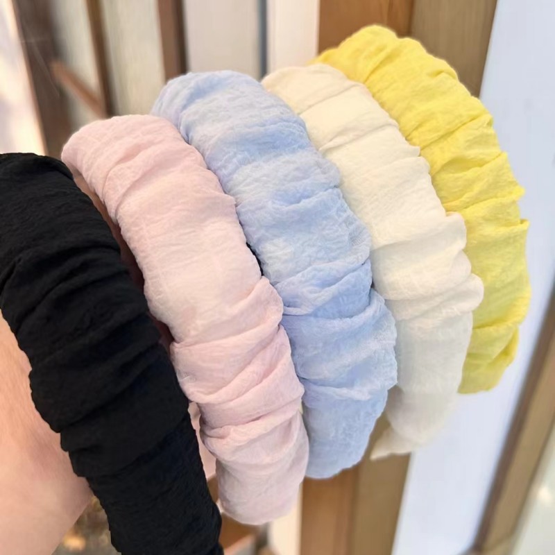 The high-end solid color wide-edge pleated hair band exudes a gentle and elegant charm. It can be used to increase height on the top of the head and is a versatile headband and hair clip accessory for going out full figure
