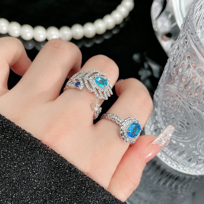 A niche design sense sea-blue zircon feather open ring for women, adorned with diamonds, a fashionable, individualistic and light luxury ring from Europe and America full figure