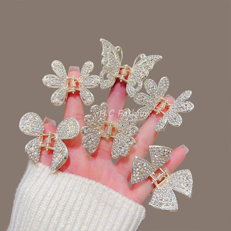 A new elegant hairpin accessory featuring a high-end water diamond butterfly claw clip, a delicate half-tied updo shark clip at the back of a woman's head full figure