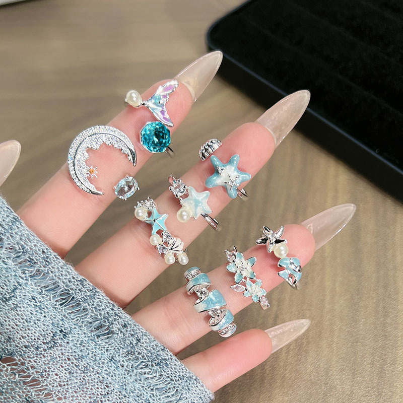 The new ice blue series ocean-style starfish tail enamel open ring is a women's vacation style light luxury design ring full figure