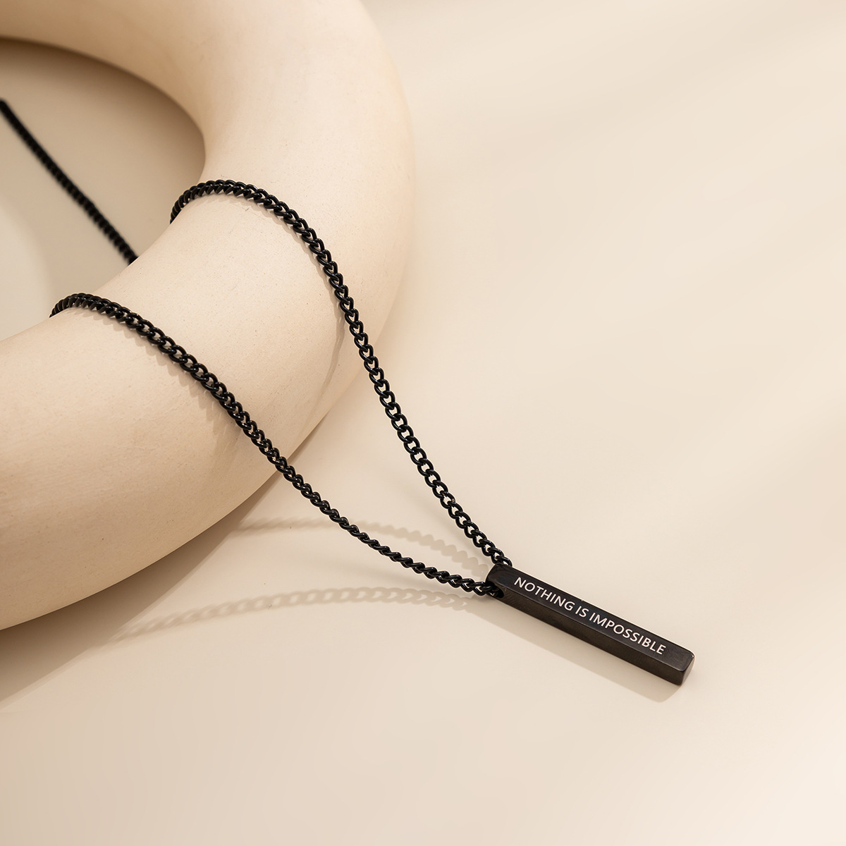 A sweet and cool black spray-painted long pendant necklace from Europe and America, a simple and elegant letter-shaped titanium steel necklace for women Application Scenario