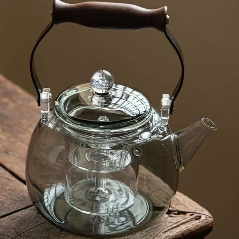 This is a large-capacity household steaming and boiling teapot with a handle. It is made of smoke grey wood and has a starry sky handle. It is a glass boiling teapot details Picture
