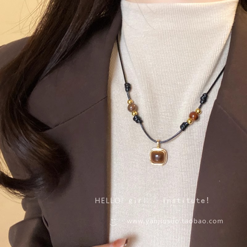 Tiger's eye stone woven leather rope necklace, a new 2024 women's light luxury and niche style sweater chain layering accessory full figure
