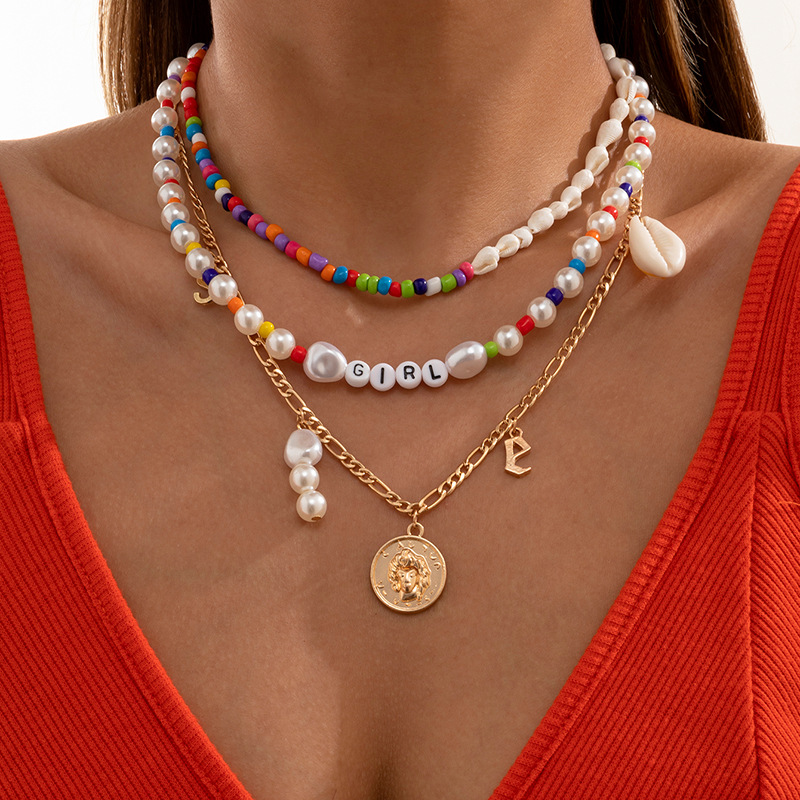 A simple and individual-style color-blocking rice bead shell woven necklace and a retro European and American imitation pearl patchwork letter necklace full figure