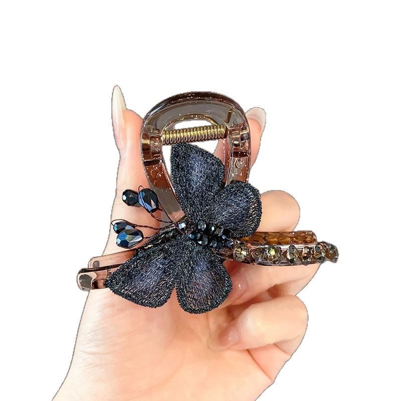 "Fall for the Butterfly ~ A retro style embroidered butterfly grab clip for a medium-sized woman with a half-tied hair at the back of her head and a shark clip hair accessory. Item Picture