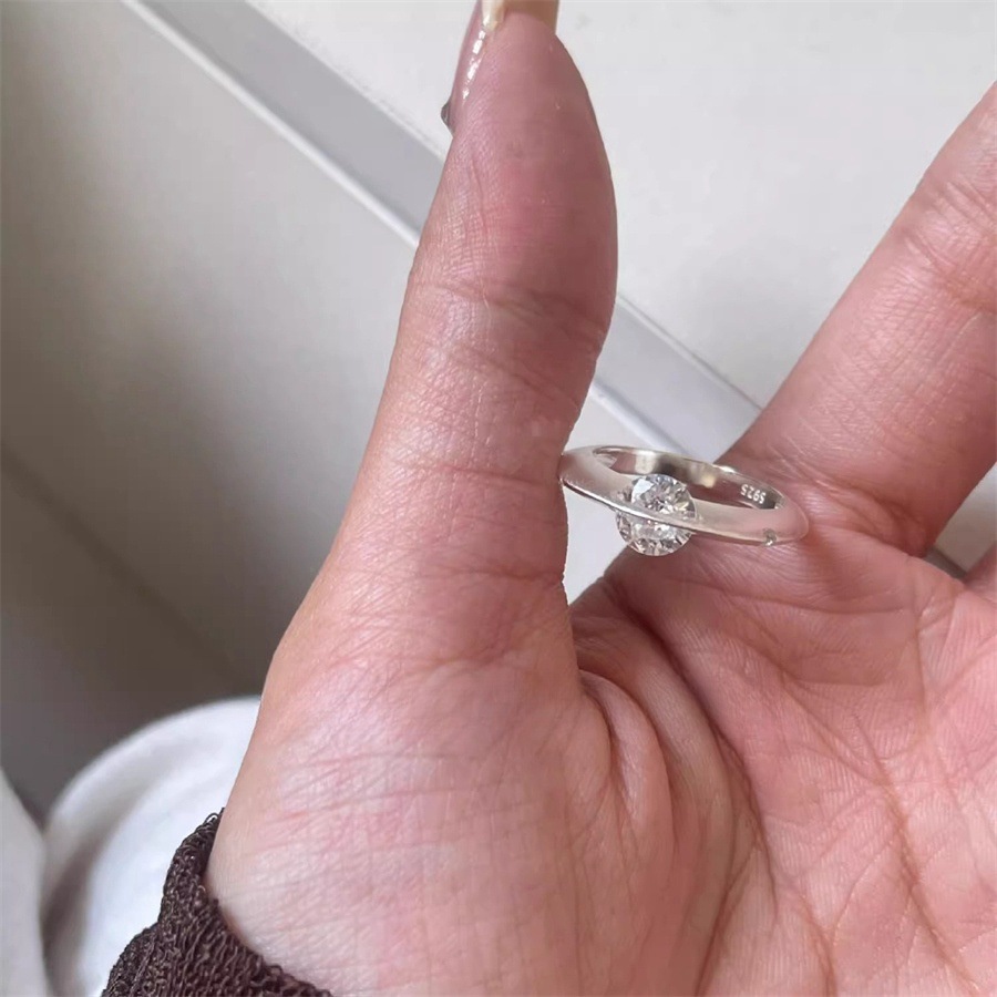 A rare and unique female design of a rotating zircon planet ring with a sparkling diamond opening details Picture