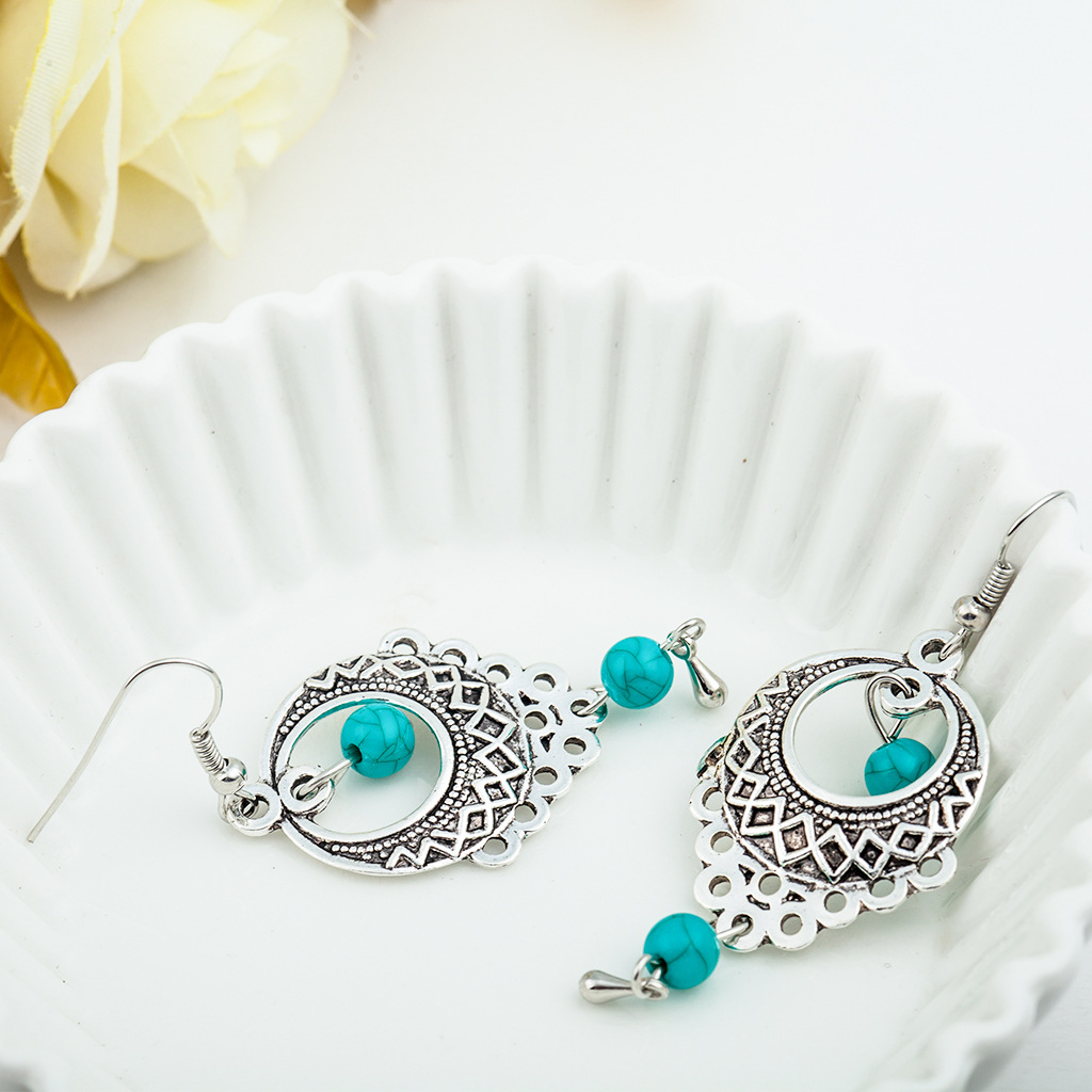 Wholesale of European and American fashion retro ethnic style hollowed-out turquoise water drop earrings and Bohemian tassel stud accessories details Picture