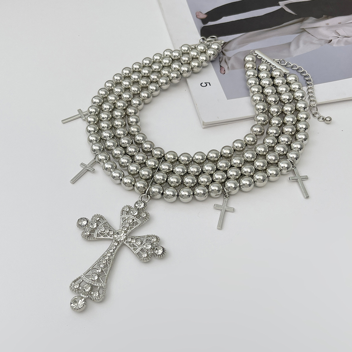 A multi-layered diamond cross necklace with a European and American light luxury style, featuring an exaggerated and unique charm. CCB round bead necklace Application Scenario