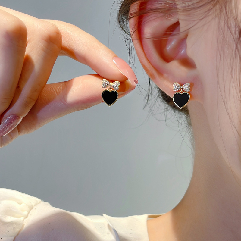 The new 925 silver needle black peach earrings are a favorite among women. The bow stud earrings feature a niche design and a cool style full figure