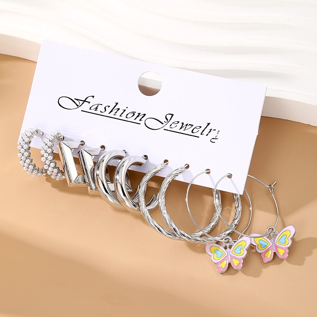A new set of fresh and sweet pearl-inlaid metal earrings featuring oil-dripping C-shaped butterfly pendant ear hooks from Europe and America details Picture