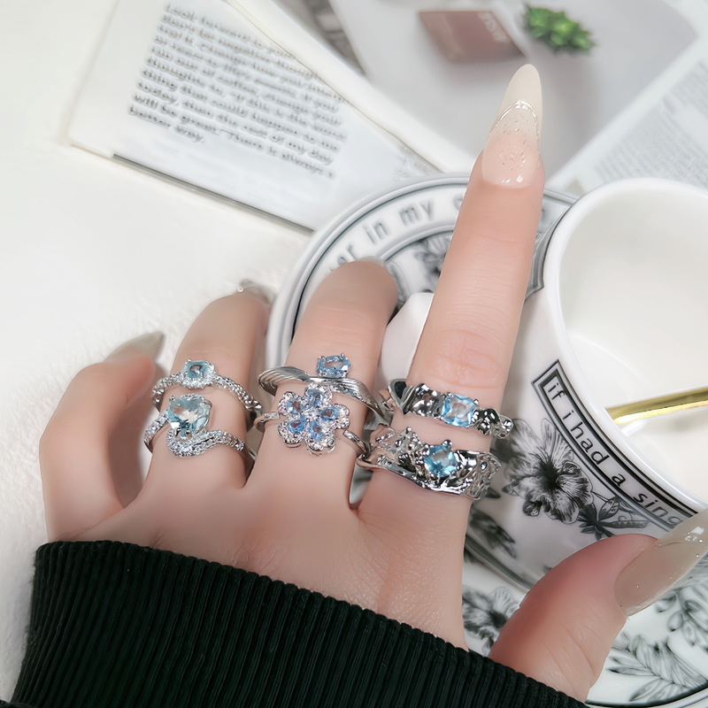 Korean-style high-end, light luxury, sea blue zircon, exquisite flower heart, fashionable ring, cold female style, niche ring trend full figure