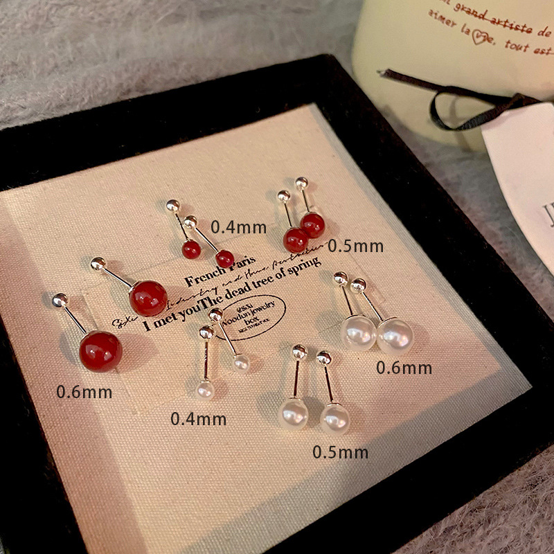 Dark red cinnabar ear studs, Korean style, fashionable and niche design, simple screw-down ear bone stud earrings wholesale Application Scenario