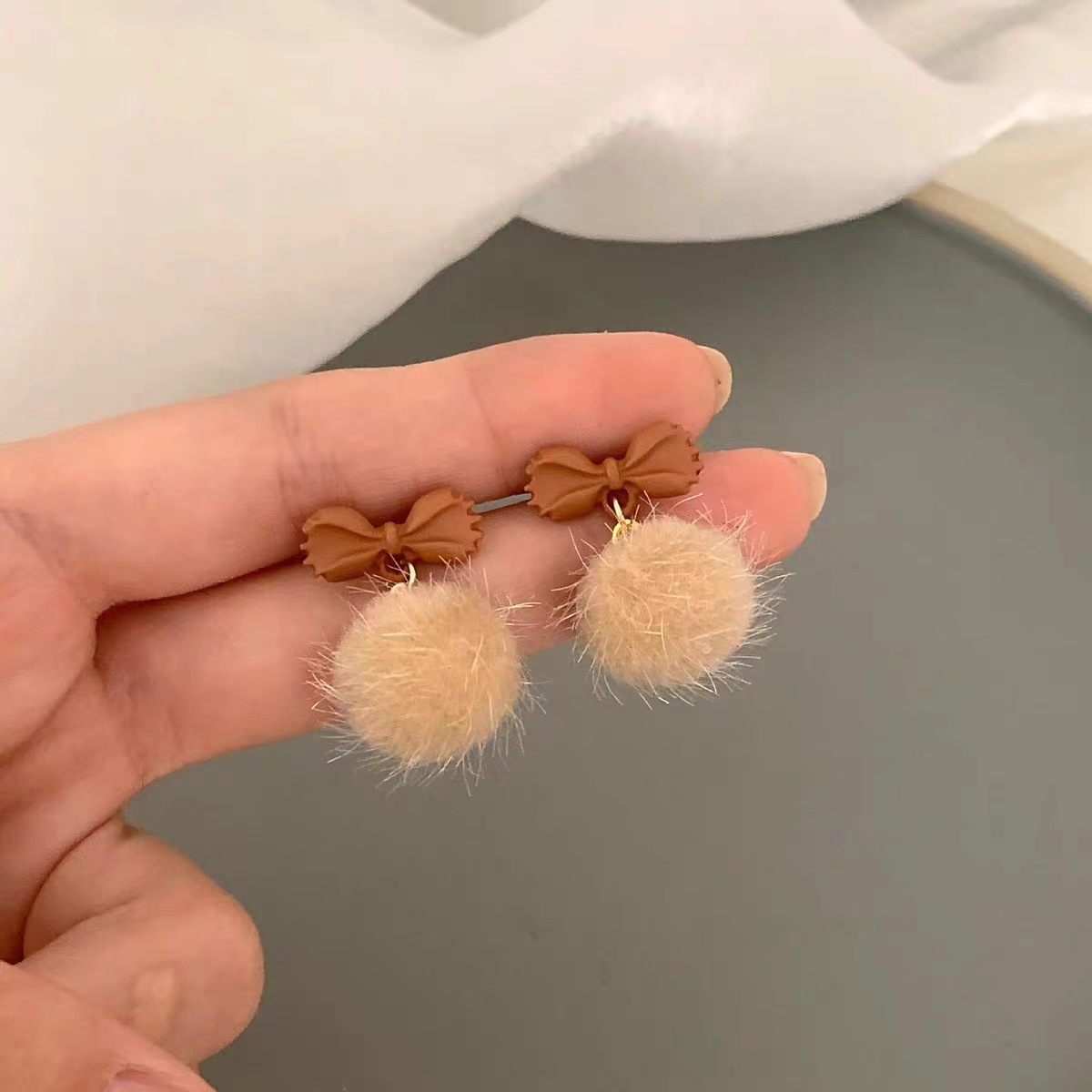 Bowknot mink pom-pom stud earrings for women's 2025 new trendy autumn and winter, plush design sense earrings, high-end and elegant earrings details Picture