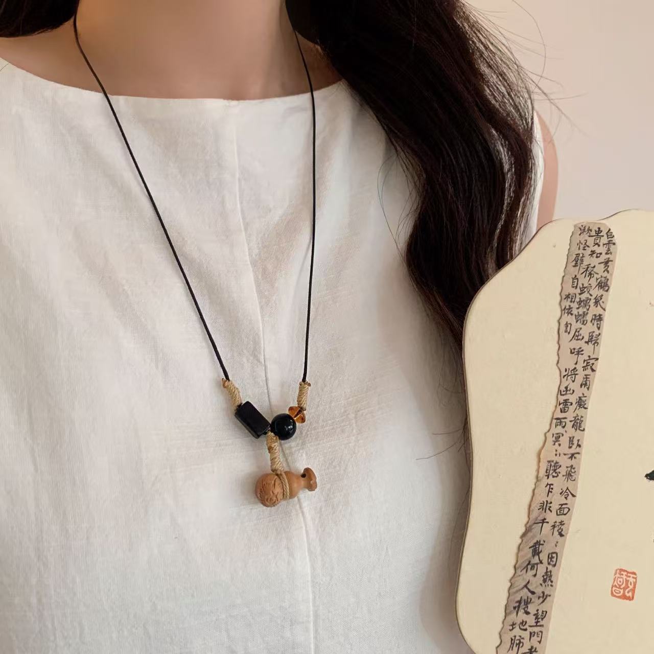 New Chinese-style Tibetan handcrafted retro peach wood small fish gourd necklace, niche sweater chain, simple and versatile necklace for autumn and winter Application Scenario