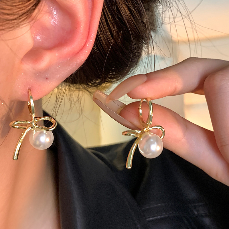Wholesale of Korean-style bow pearl ear loops for women's light luxury, niche design, versatile and popular irregular metal earrings details Picture