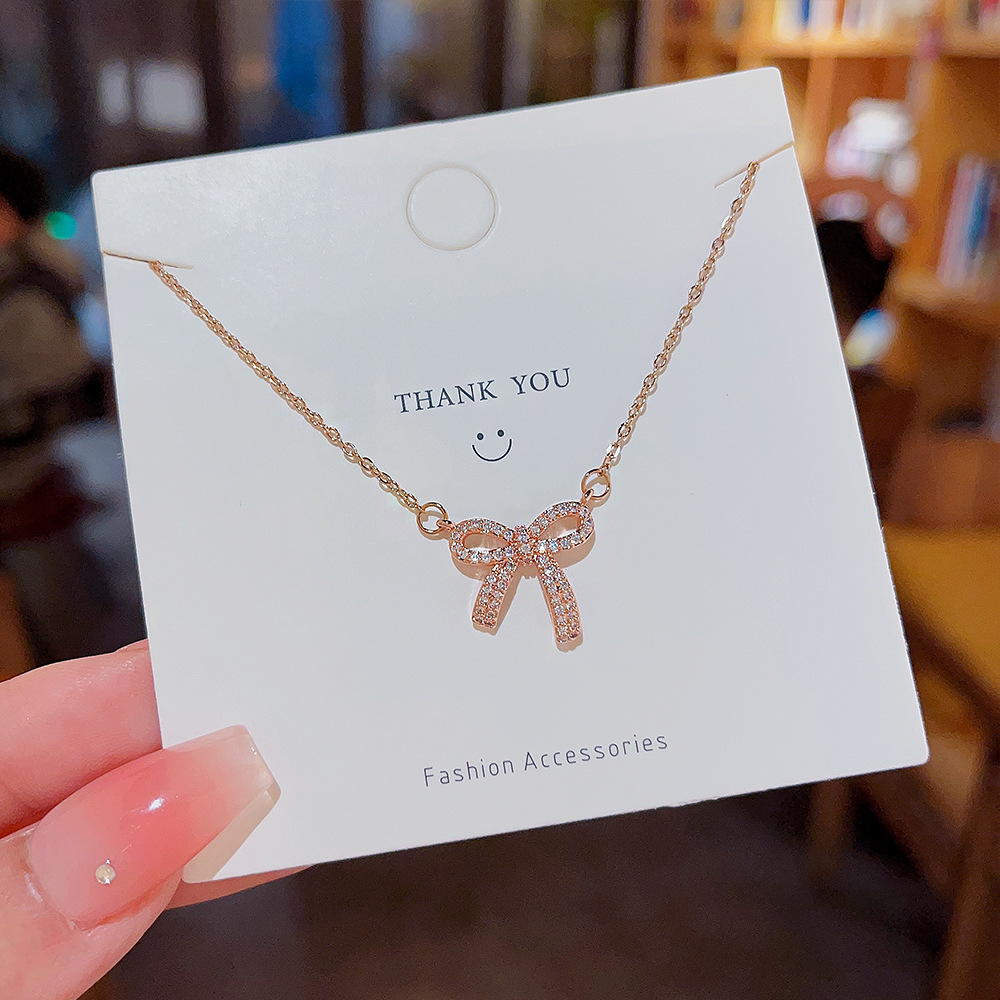 Sweet and cool hot girl micro-inlay bow pendant titanium steel necklace, female Internet celebrity's unique design sense and temperament collarbone chain wholesale Specification drawing