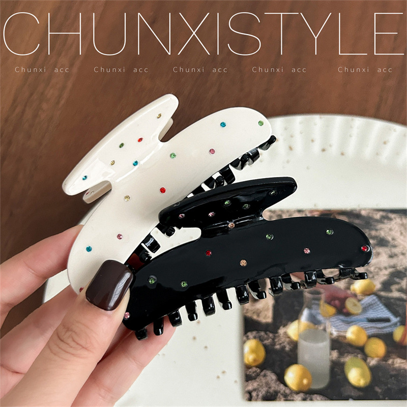 A new polka dot hair clip headwear featuring a sweet and cute Korean color diamond scratch-clip on the back of a woman's head and a stylish shark clip Application Scenario