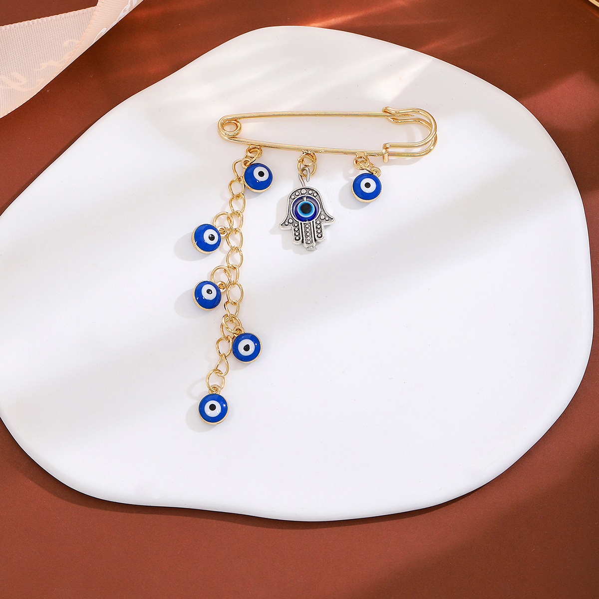 European and American creative diamond-encrusted devil's eye tassel brooch, high-end feel, blue eye cinched waist sweater, cold style brooch Specification drawing