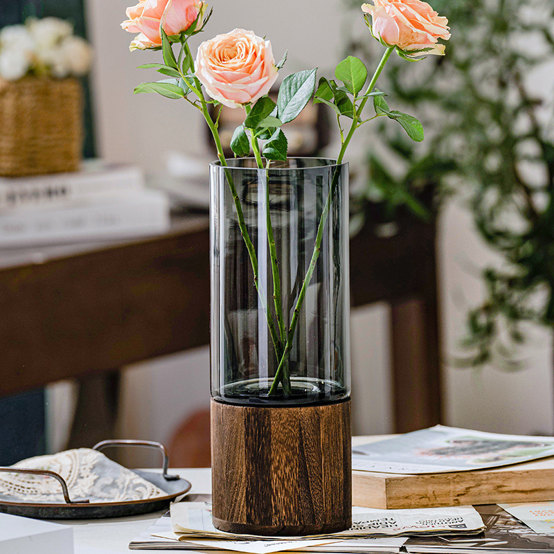A Nordic light luxury glass vase with a wooden base and water-grown roses, a creative flower arrangement for decorating dining tables and living rooms details Picture