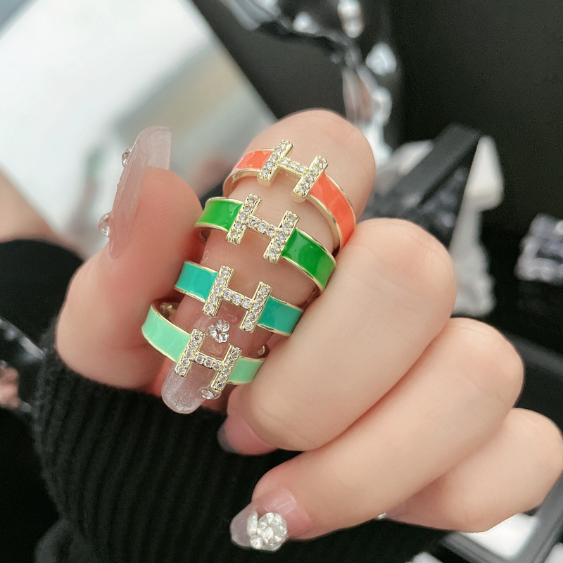 A Mambo style mint green enamel drop glaze H-letter open ring for women, a retro, light luxury, and court-style fashionable ring full figure