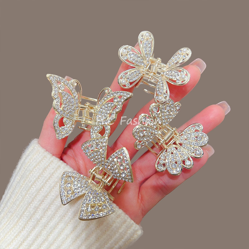 A new elegant hairpin accessory featuring a high-end water diamond butterfly claw clip, a delicate half-tied updo shark clip at the back of a woman's head details Picture