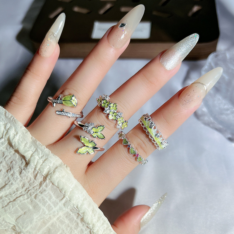 The "Flower Bloom" series features a fresh and delicate design with a light green, sweet and exquisite open ring, a butterfly flower ring for women details Picture