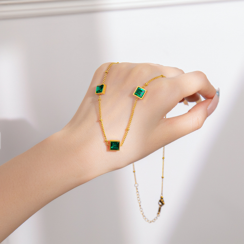 Doudou Chain, a luxurious titanium steel necklace with three green diamonds, exudes a fashionable and sophisticated feminine charm. It's a popular collarbone chain and a versatile accessory full figure