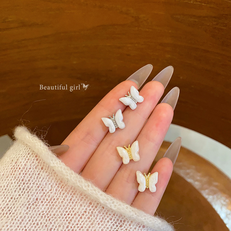 Super fairy-like white oil-dripping butterfly stud earrings for women, unique and simple earrings, light luxury and high-end elegance, wholesale of internet-famous earrings full figure