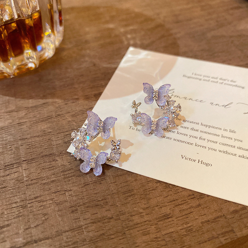 Super fairy blue diamond-encrusted butterfly earrings, cold style, niche design sense, elegant stud earrings, fashionable and versatile earrings wholesale Application Scenario