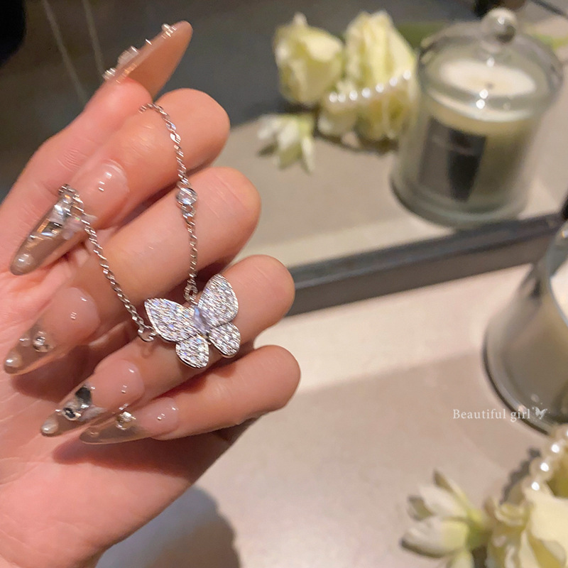 A full-diamond zircon butterfly titanium steel necklace with a high-end feminine touch and a light luxury style. It features a collarbone chain and is a popular sweater chain accessory full figure