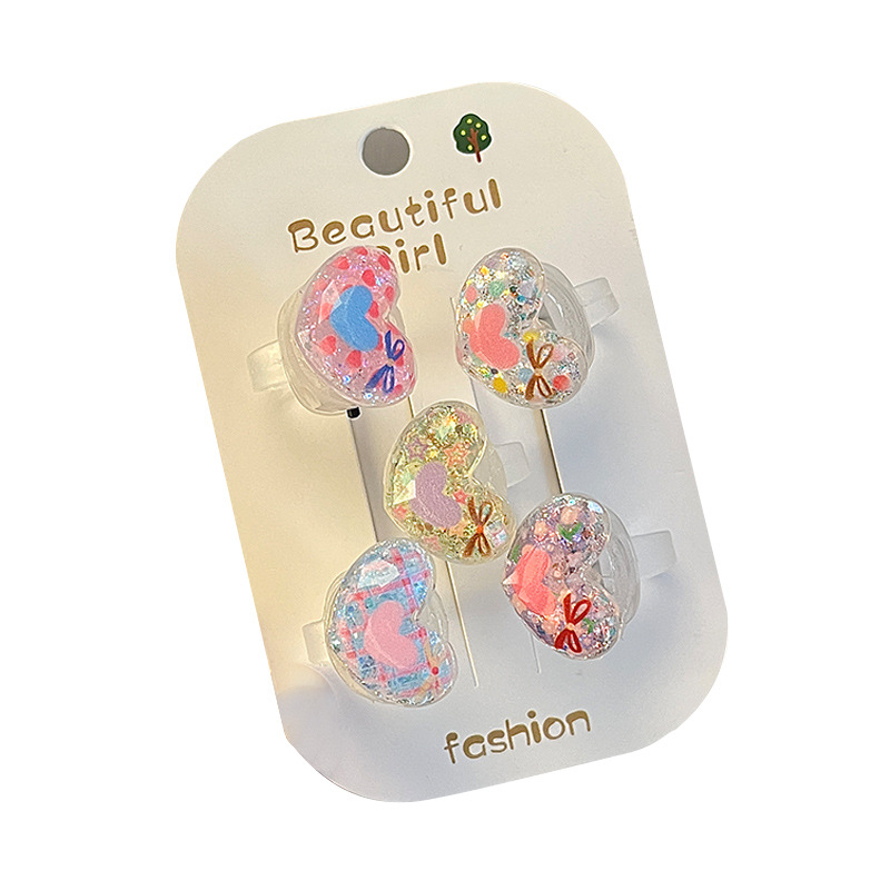 A cute little girl with a flowing sand glowing ring, a flashing light ring with a switch, cartoon jewelry, and a girl's ring Item Picture