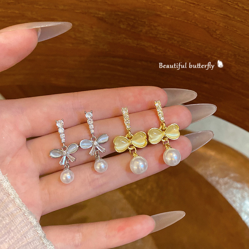 Diamond-encrusted cat's eye stone tassel bow stud earrings, women's niche design sense pearl earrings, summer bestsellers wholesale full figure