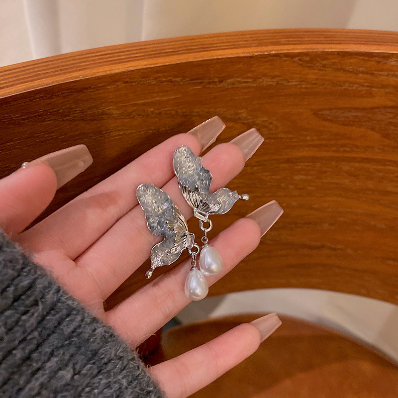 The super ethereal butterfly wing pearl tassel earrings are a light luxury and niche design for women, exuding a sense of sophistication. They are a hit earpiece that has become a social media sensation full figure