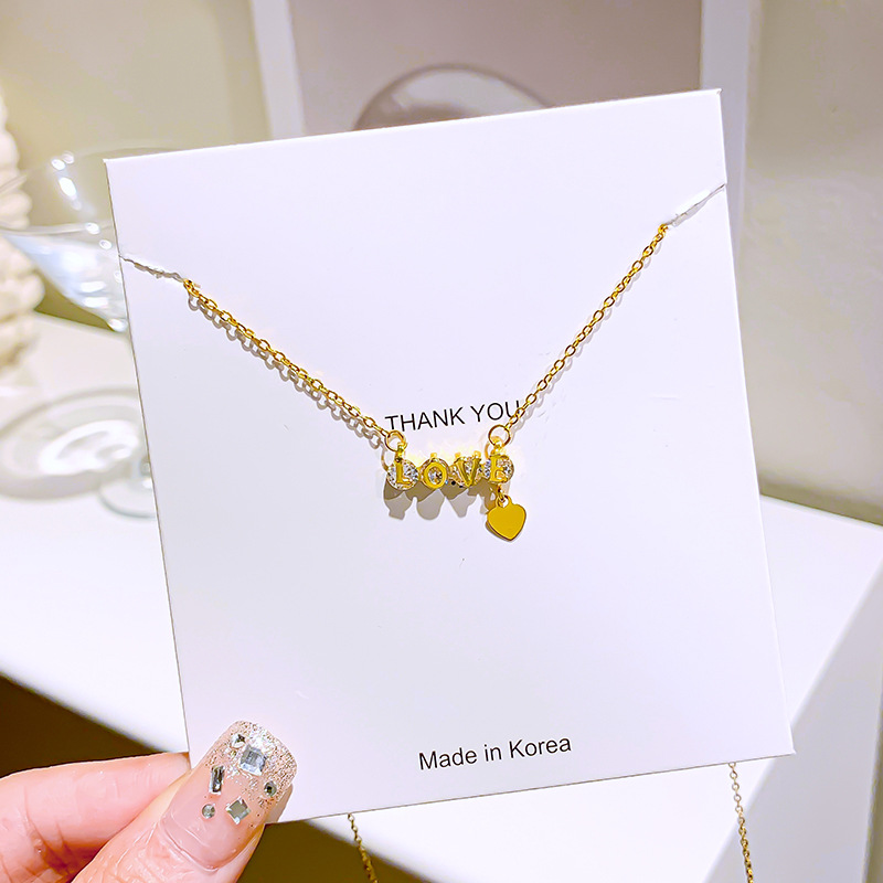 "love letter diamond-encrusted titanium steel necklace, women's heart-shaped tassel pendant, niche internet-famous light luxury collarbone chain accessory wholesale. Application Scenario