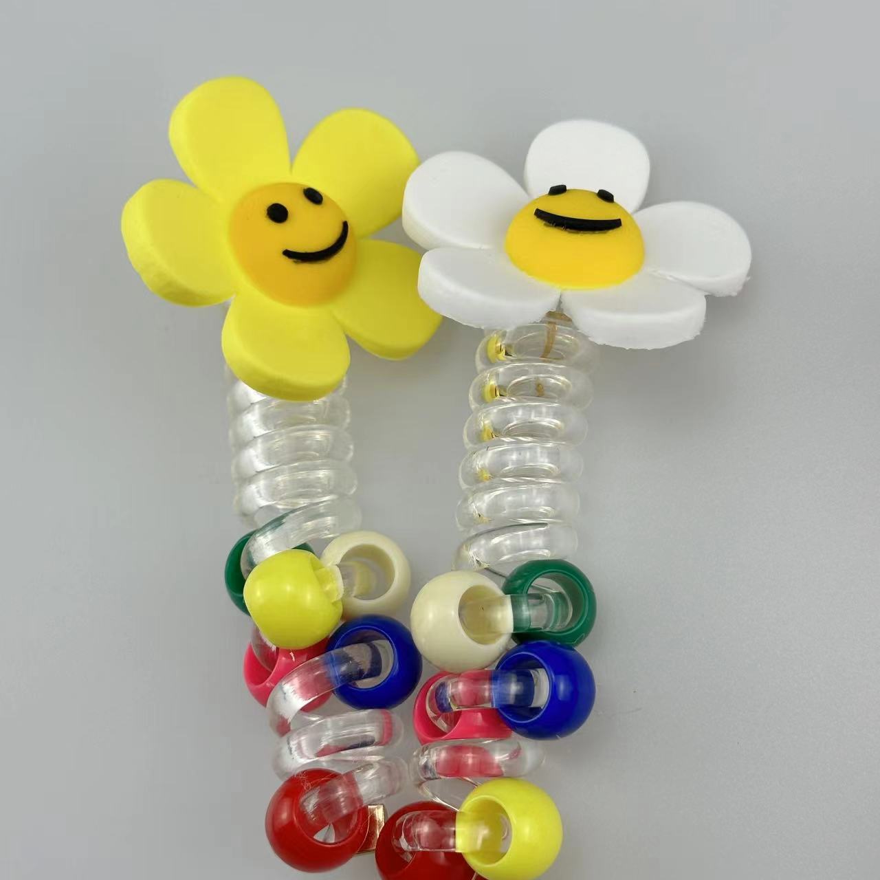 A girl's sunflower telephone line hair tie with a smiling face, a transparent ponytail braid, a hair braiding tool, and a beaded hair string accessory Specification drawing