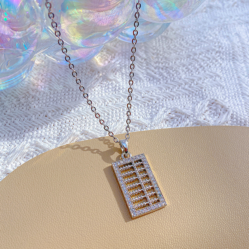 A light luxury Japanese and Korean pendant with a small abacus and titanium steel necklace, a fashionable collarbone chain by a female Internet celebrity, and a niche high-end accessory Application Scenario