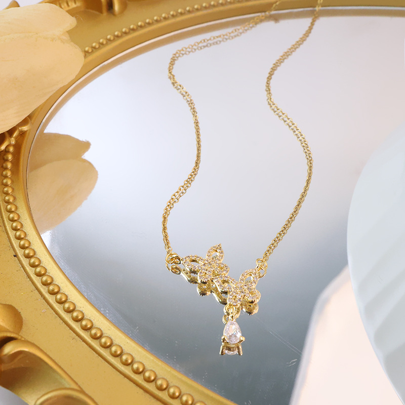 Korean style double butterfly titanium steel necklace for women, zircon water drop tassel pendant, fashionable and light luxury accessory wholesale Application Scenario