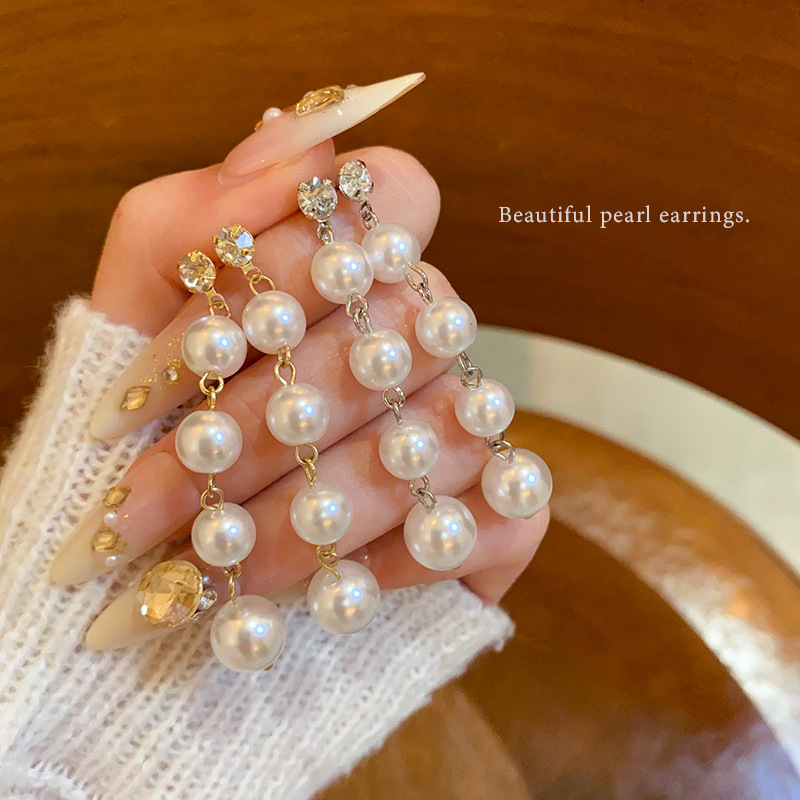 Long pearl stud earrings, exaggerated tassel earrings with a European and American style, exude a light luxury and high-end charm, and are popular earrings on the Internet full figure