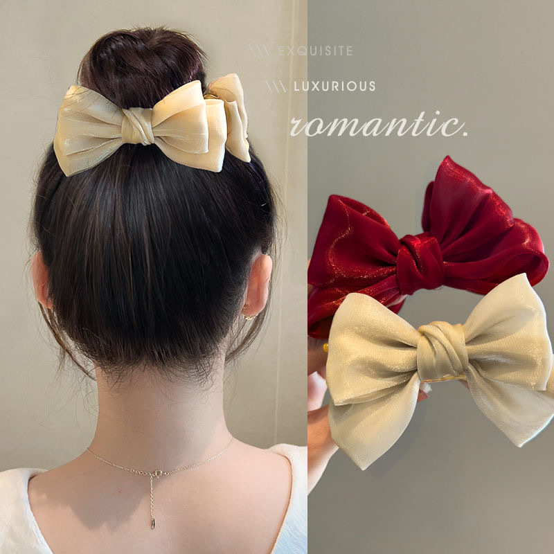 A cute red bow bun clip for a princess on the run, a popular hair accessory for both children and adults details Picture